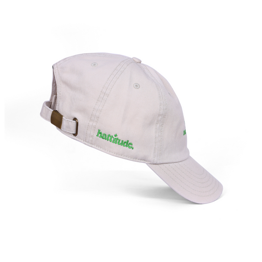 Offwhite cap with 'hatitude' logo on a white background