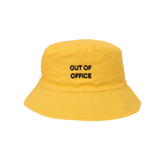 Yellow bucket hat with 'OUT OF OFFICE' text on a white background