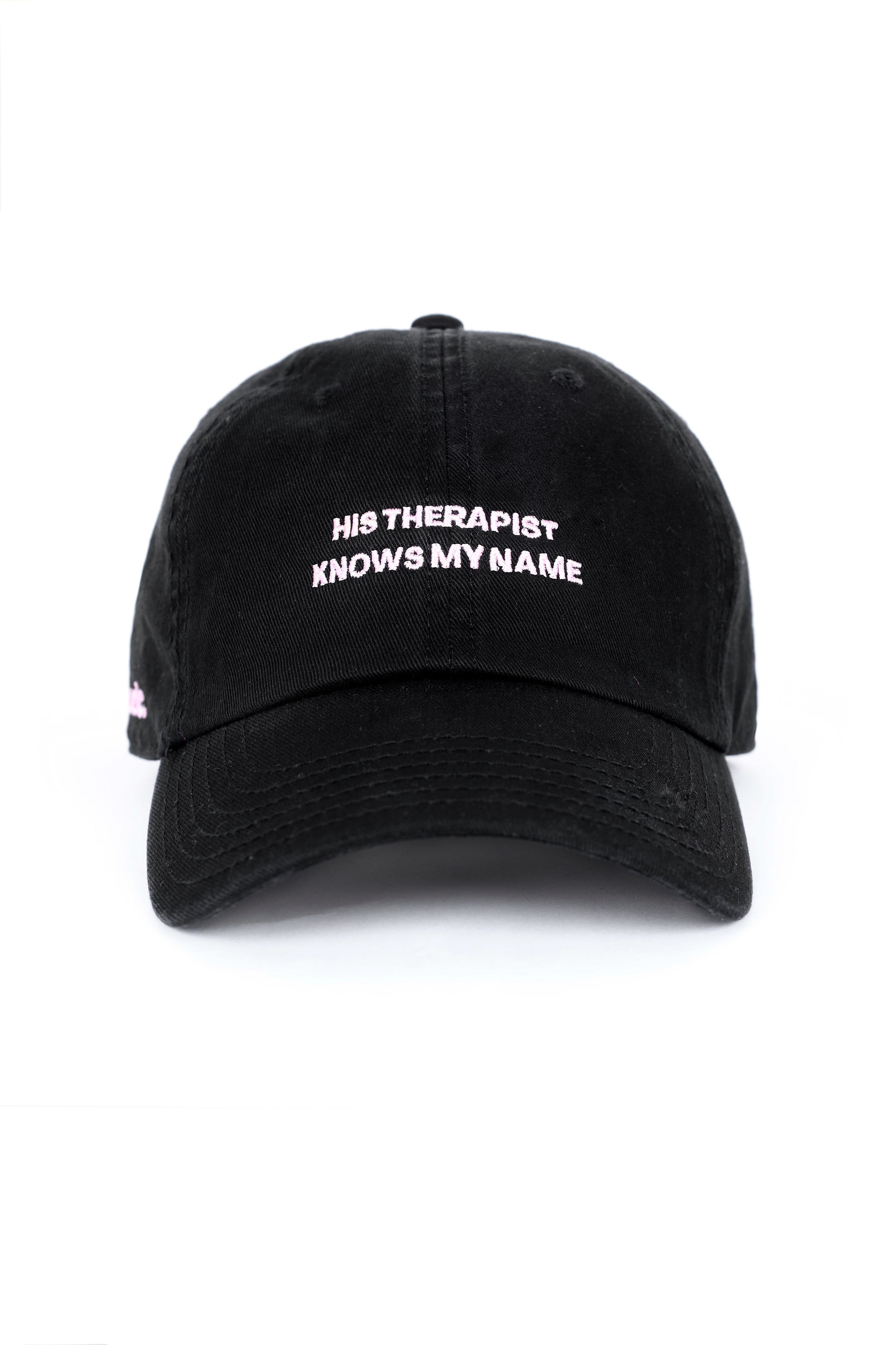 Black cap with embroidered text “His Therapist Knows My Name,” bold relationship-inspired cap.
