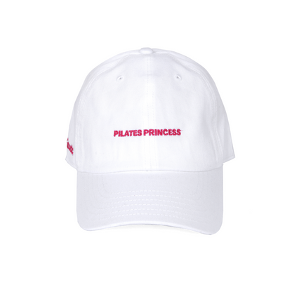 White cap with pink embroidered text “Pilates Princess,” trendy workout cap for women